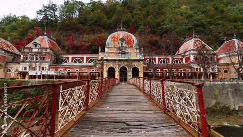 Abandoned buildings and the bridge of Baile Herculane town in Romania photo