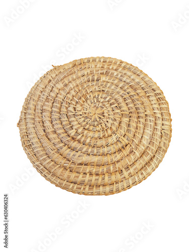 View of handmade round beige wicker tablecloth surface isolated on white background; Close-up of single oval water mat of water hyacinth fabric. Rustic decoration. Environmentally friendly. Household.