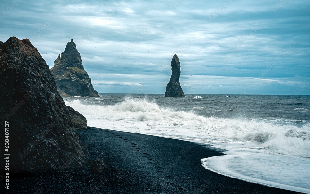Stunning shot of the black sand Reynisfjara Beach with rock formations in Iceland