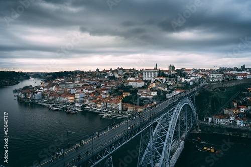 Aerial view of the Ponte Dom Luis bridge near the skyline of Porto, Portugal © João Silva/Wirestock Creators