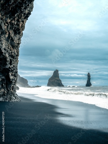 Stunning shot of the black sand Reynisfjara Beach with rock formations in Iceland © João Silva/Wirestock Creators