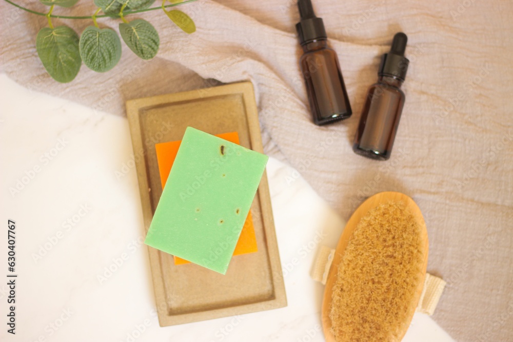 Top view of a selection of body care items including a soap bar, a massage brush, and spray bottles Top view of a selection of body care items including a soap bar, a massage brush, and spray bottles