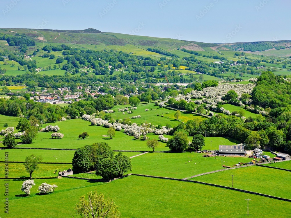 Stunning rural landscape featuring vibrant green fields and hills. Derbyshire, England.