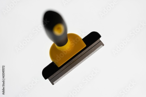 Closeup of dogs grooming brush on a white background with copy space photo