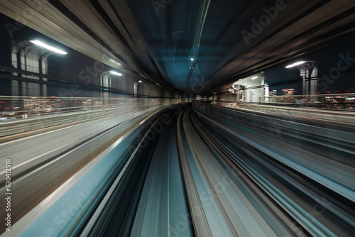 Motion blurred of train moving inside tunnel with daylight in tokyo, Japan. © yaophotograph