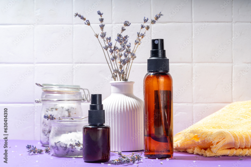 Cosmetics with lavender oil and dry lavender flowers. Aromatic essential oil, lavandula salt, spray, beauty care, wellness and natural beauty concept