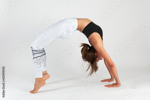 Woman performing a yoga pose in a studio setting
