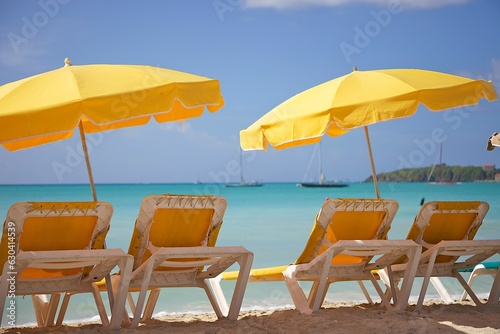 Scenic view of beach chairs with umbrellas on a sandy beach on a sunny day