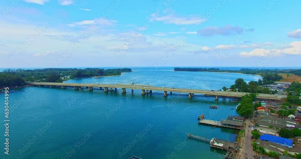 .Aerial view beautiful Sarasin bridge on the blue sea..Sarasin bridge is important route connecting by land..Scene of white cloud in blue sky and green sea..the bridge connect Phuket to Phang Nga.. .Aerial view beautiful Sarasin bridge on the blue sea..Sarasin bridge is important route connecting by land..Scene of white cloud in blue sky and green sea..the bridge connect Phuket to Phang Nga..