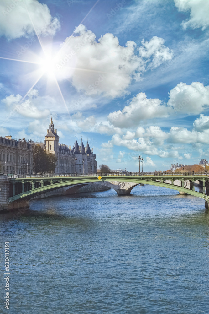 Paris, the Notre-Dame bridge, and the Conciergerie on the ile de la Cité, sun star
