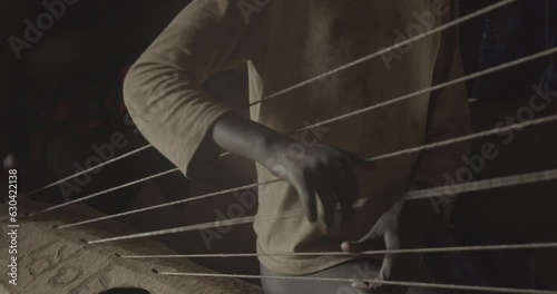 Mundari child playing local chordophone Terekeka South Sudan photo