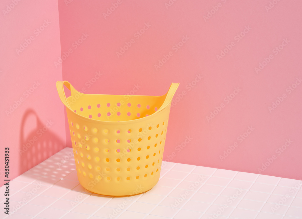 Empty bright yellow laundry basket. Copy space for text. Empty bright yellow laundry basket. Copy space for text.