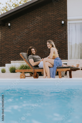 Young couple relaxing by th...