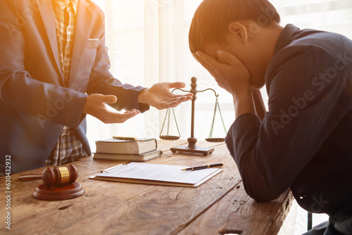 A young businessman clutches his face in stress after a court ruled his business bankrupt because investments failed to meet targets and caused huge debts to the bank and filed for bankruptcy.