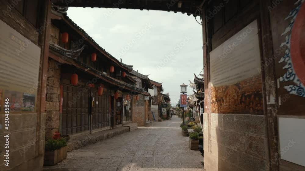 Chinese Ancient Town of Baisha, Walking Through an Old Arch of an Old Asian Town. Chinese Translation: Chinese Ancient Town of Baisha, Walking Through an Old Arch of an Old Asian Town. Chinese Translation: