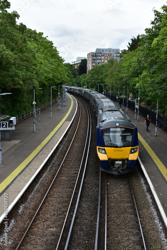 GREENWICH  UK  JUNE 2022   YELLOW LONDON OVERGROUND ARRIVING TO GREENWICH STATION  