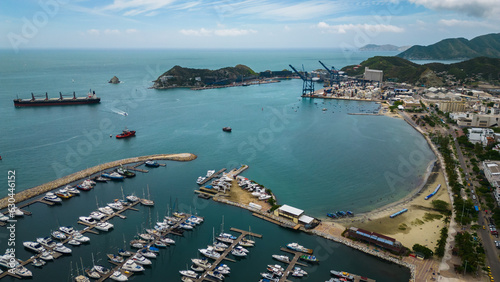 aerial Santa Marta City Marina, Colombia, Aerial View of Sailboats, Breakwater and Cityscape Skyline Sierra Nevada mountain and luxury hotel in the rodadero