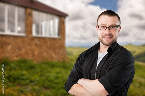 Smiling man posing on outdoor background