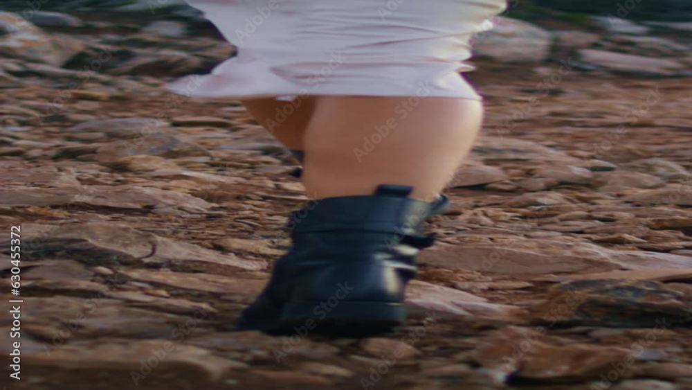 Slim woman feet walking cliff with rock back view. Unknown model crossing nature Slim woman feet walking cliff with rock back view. Unknown model crossing nature
