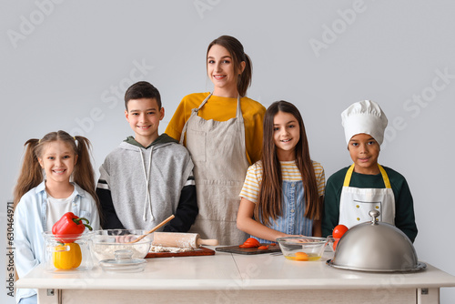 Female chef with group of l...
