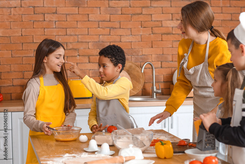 Female chef with group of l...