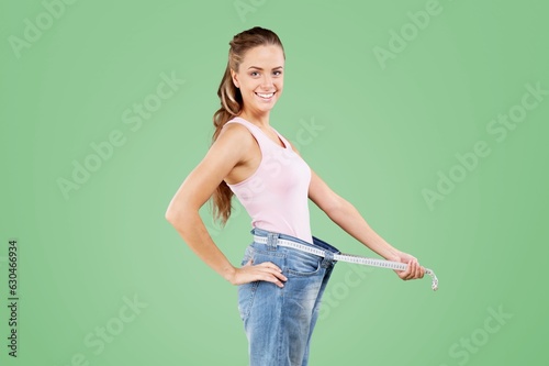 Young woman wear after weightloss posing on background