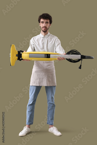 Young man with vacuum clean...