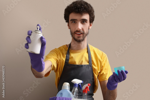 Young man with bucket of cl...