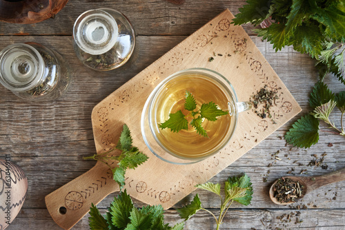 Nettle tea in a cup on a table, top view