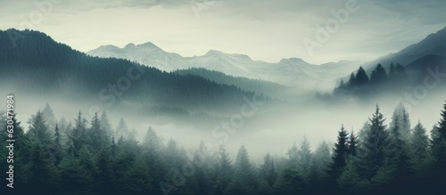 A vintage retro hipster-style landscape with a misty foggy mountain, fir forest, and space for text.