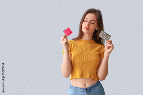 Young woman with condom and...