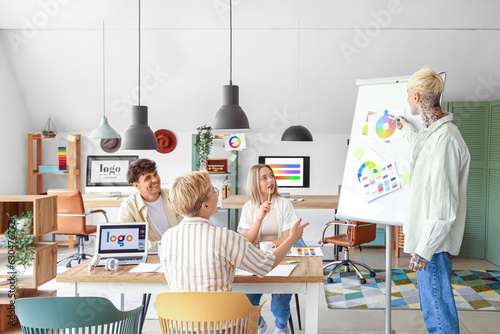 Team of graphic designers working with color palettes in office