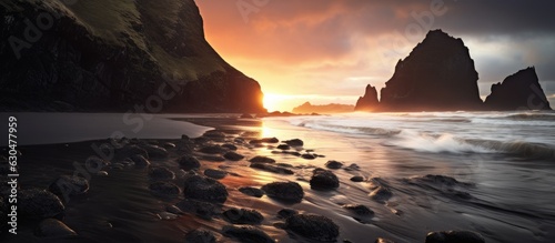 A picture of Karekare Beach at sunset in Waitakere, Auckland, captured using a long exposure technique.