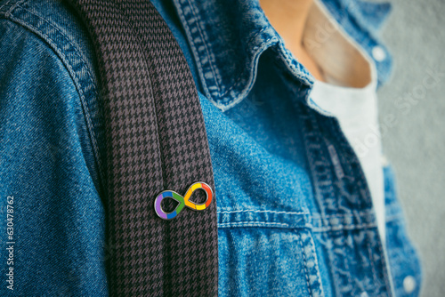 Young boy with autism infinity rainbow symbol sign. World autism awareness day, autism rights movement, neurodiversity, autistic acceptance movement photo