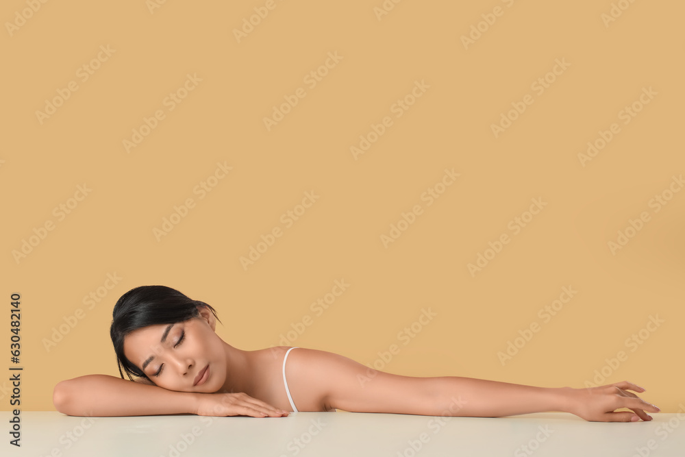 Fototapeta premium Beautiful young Asian woman with healthy skin on beige background
