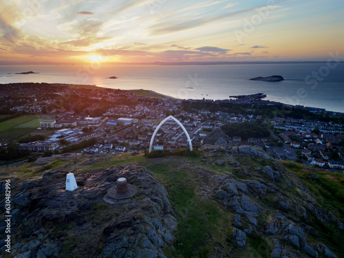 Aerial view of the whale bone monument on top North Berwick law in Scotland at sunset