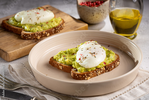 Wholemeal toast with avocado and poached egg. photo