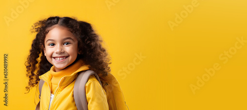 Cute Young Girl with a Backpack Heading Back to School on a Yellow Banner with Space for Copy