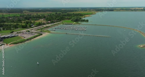 Establishing shot of lake in the center of France in the Champagne region. Orient forest regional natural park near Troyes city. Aerial view of beach artificial lakes with calm clear water in France photo
