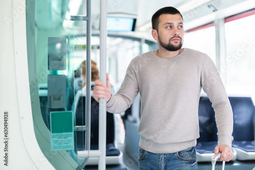 Portrait of male passenger in tram car on a spring day