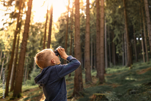 Child in the forest looking through binoculars exploring nature and wildlife  © kieferpix