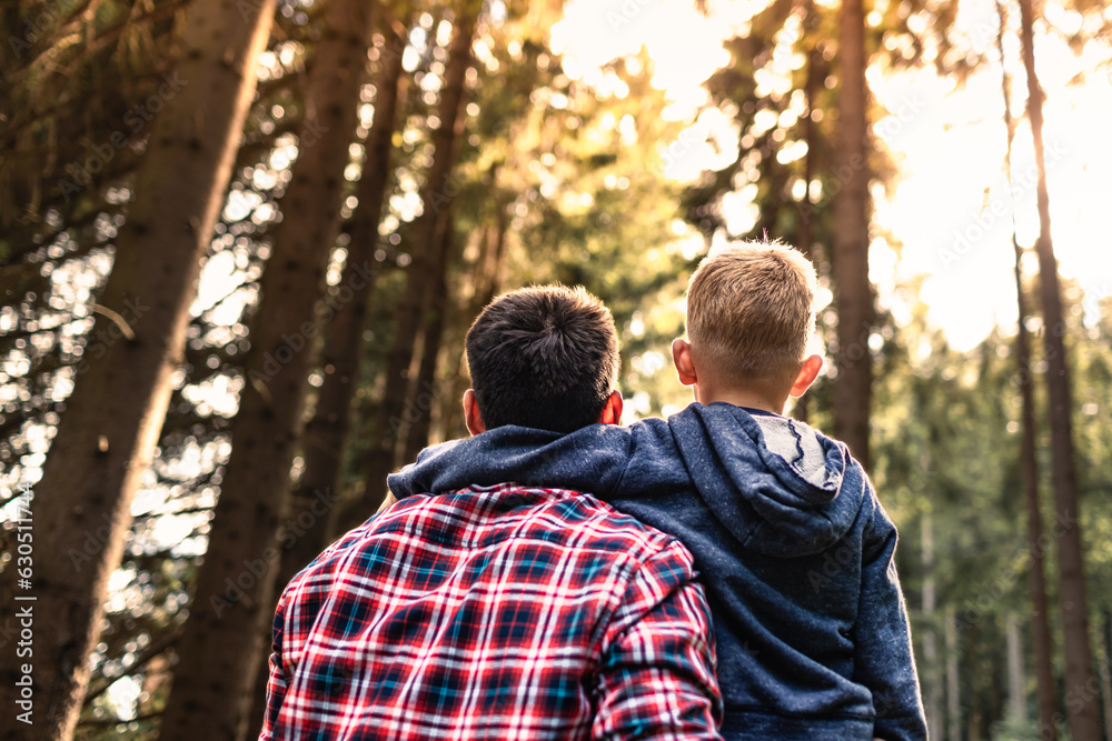 Father son enjoying nature forest setting. Family adventure exploring outdoors together Father son enjoying nature forest setting. Family adventure exploring outdoors together