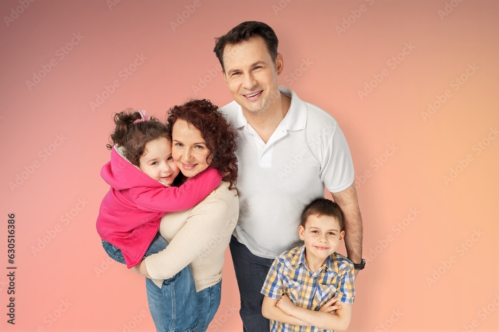Young parents with child posing together on background