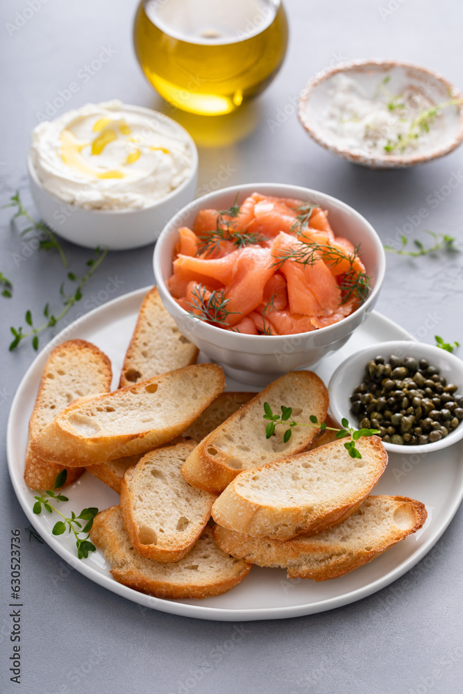 Making salmon and cream cheese bruschetta with dill and capers