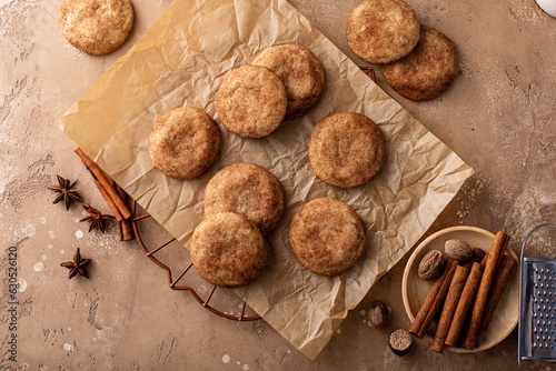 Cinnamon cookies on a parchment paper with milk