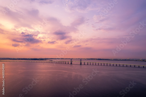 Aerial photo of Qingdao Jiaozhou Bay Cross Sea Bridge under sunset..