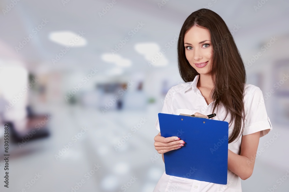 Portrait of corporate worker woman with clipboard at work