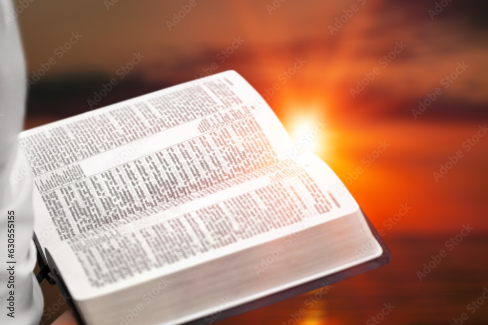 Fototapeta premium Christian person holds bible books in hands.