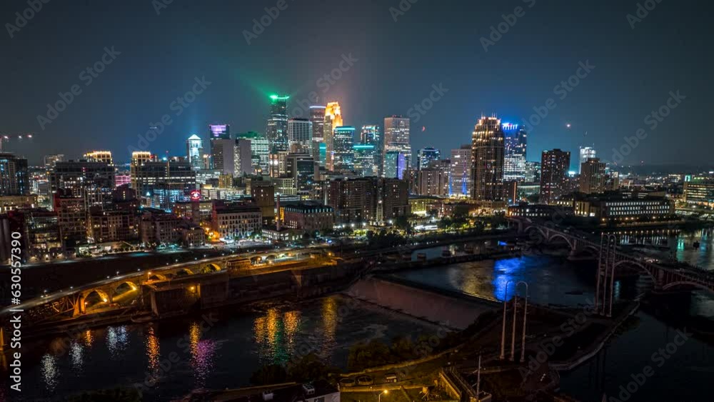 Drone night hyperlapse over Mississippi river of illuminated Minneapolis skyline Drone night hyperlapse over Mississippi river of illuminated Minneapolis skyline