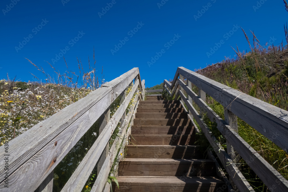 Stair case on sand dunes at Oregon pacific coast reaching to sky
